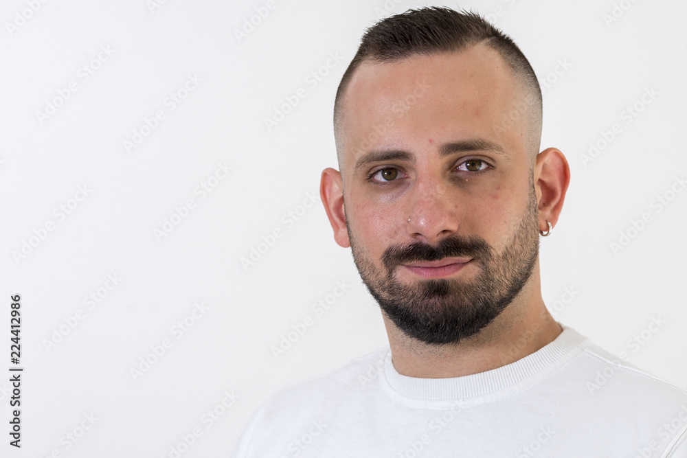young businessman with tattoo, black t-shirt, beard and black hair, and with a white background young businessman with tattoo, black t-shirt, beard and black hair, and with a white background