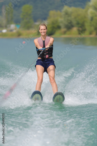 young woman water skiing on a sea