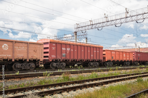 Trains with goods and freight cars are on the railway