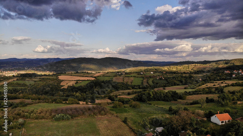 Aerial view of beautiful autumn sunset with a lot of clouds. Amazing colors and shadows of the clouds on the land. Landscape of village in Sumadija near the Kragujevac.