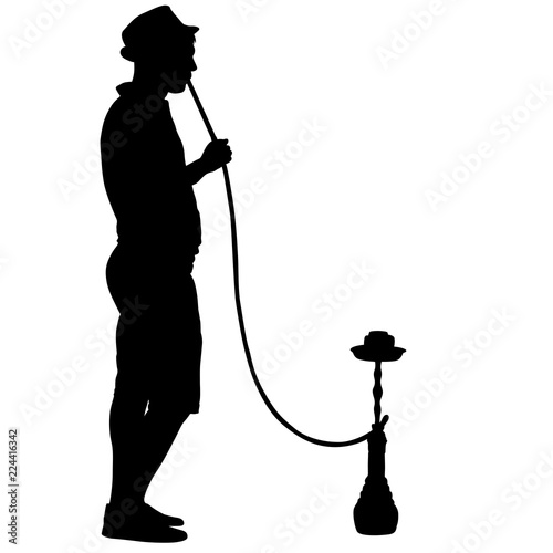 Silhouette of a man smoking a hookah standing beside him