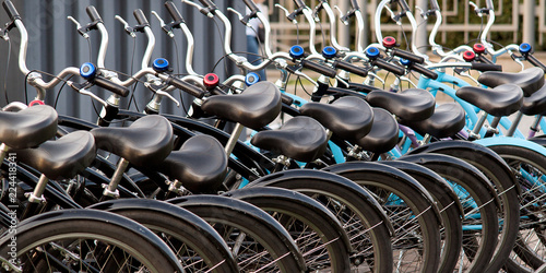 several bicycles stand in a row at the rental office or in a shop in the summer city