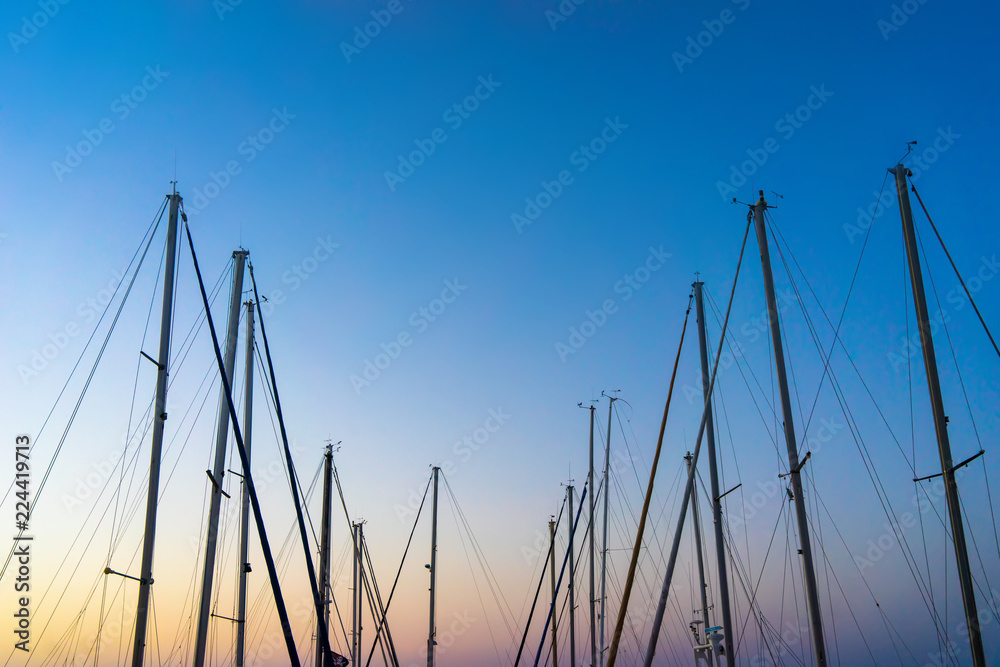 The evening sun and yacht mast silhouette.
