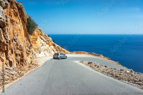 Fototapeta Naklejka Na Ścianę i Meble -  Car on the steep and shallow dangerous mountain road