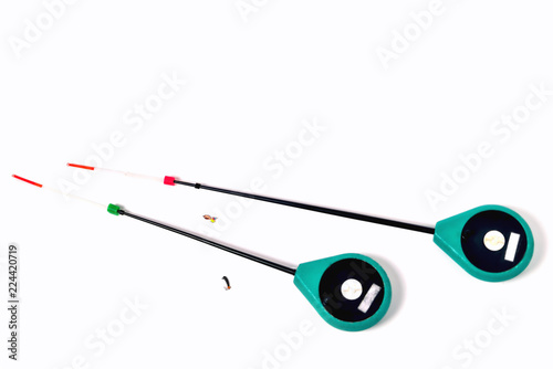 Fitted fishing rods for winter fishing on a white background, close-up
