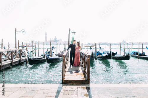 Romantic travel couple in Venice on Gondole ride romance in boat happy together on travel vacation holidays. Romantic young beautiful couple sailing in venetian canal in gondola. Italy, Europe. © sofiko14