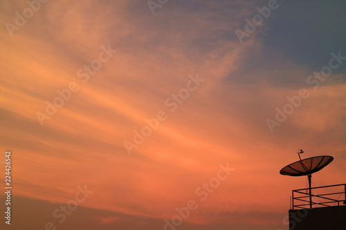Stunning Vibrant Color of Sunset Afterglow with the Silhouette of Satellite Dish 