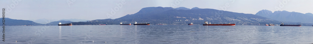 View of the Burrard Inlet looking towards English Bay, Vancouver, British Columbia, Canada; North shore mountains visible from the Spanish Banks Beach Park