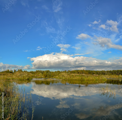 Sunny autumn day on the shore of an artificial lake.