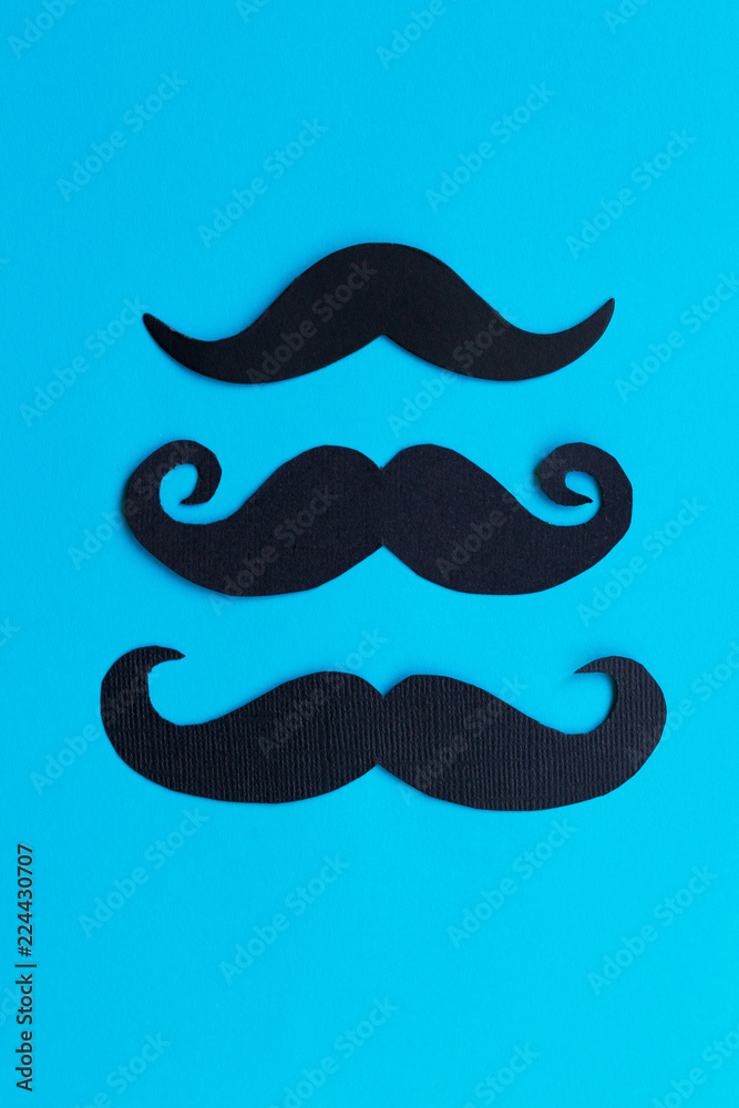Mustache patterns on the blue background. November movember concept.