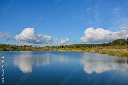 Sunny autumn day on the shore of an artificial lake.