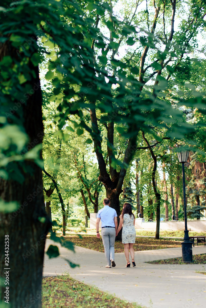 Obraz premium young loving couple walking in the park outdoors