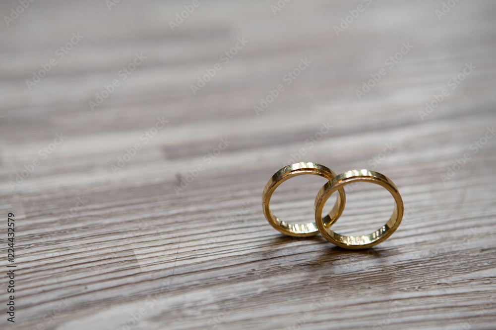 Wedding rings gold on a wooden surface, morning wedding preparation Wedding rings gold on a wooden surface, morning wedding preparation