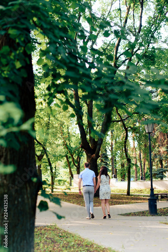 young loving couple walking in the park outdoors