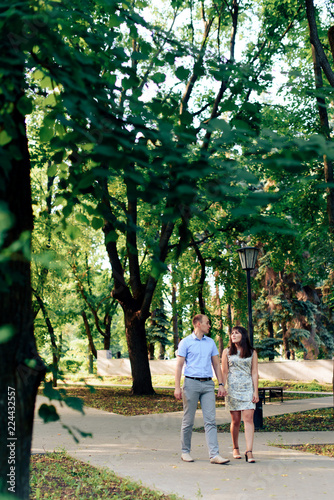 young loving couple walking in the park outdoors