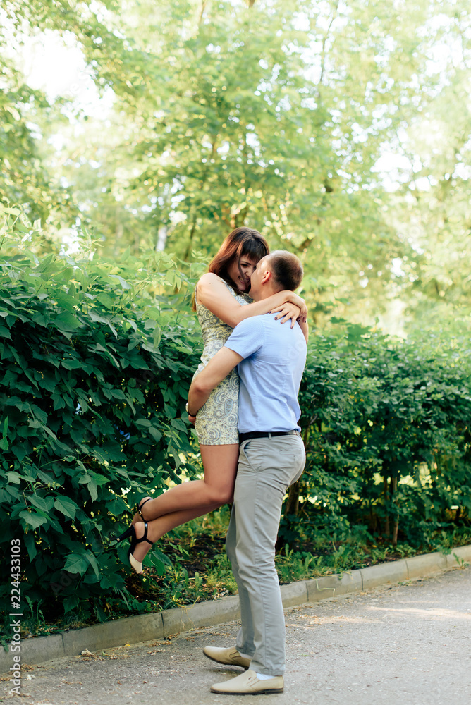 young loving couple walking in the park outdoors young loving couple walking in the park outdoors