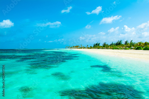 Fototapeta Naklejka Na Ścianę i Meble -  Beautiful sandy beach with sunbeds and umbrellas in Indian ocean, Maldives island
