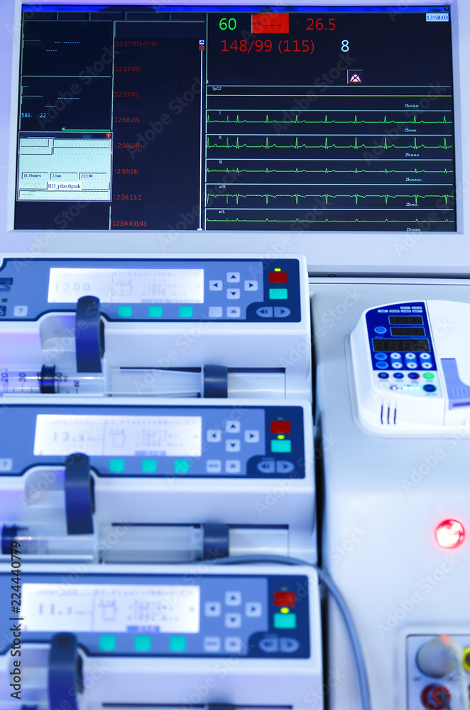 rows of panels of modern medical equipment, blurring depth of field, monitors and keys close-up, blue toning rows of panels of modern medical equipment, blurring depth of field, monitors and keys close-up, blue toning