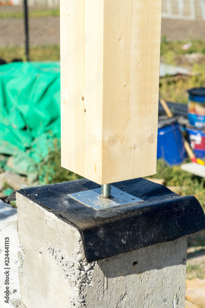 Adjustable wooden post support. Construction of a wooden house. Adjustable wooden post support. Construction of a wooden house.