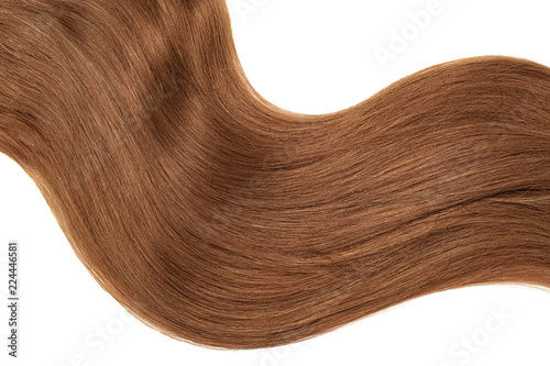 Curl of natural brown (dark) hair on white background. Wavy ponytail