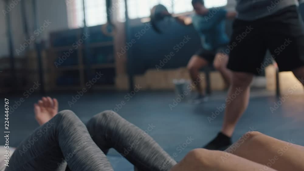 fitness athletes training sit ups exercise friends enjoying intense workout together doing cardio practice in gym bodybuilding cross fit challenge