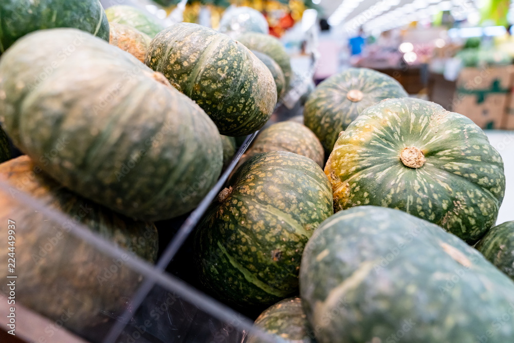 Pumpkins are vegetable that has rich in vitamins and water. They are displaying on stall to sell to somebody, and looks very fresh.