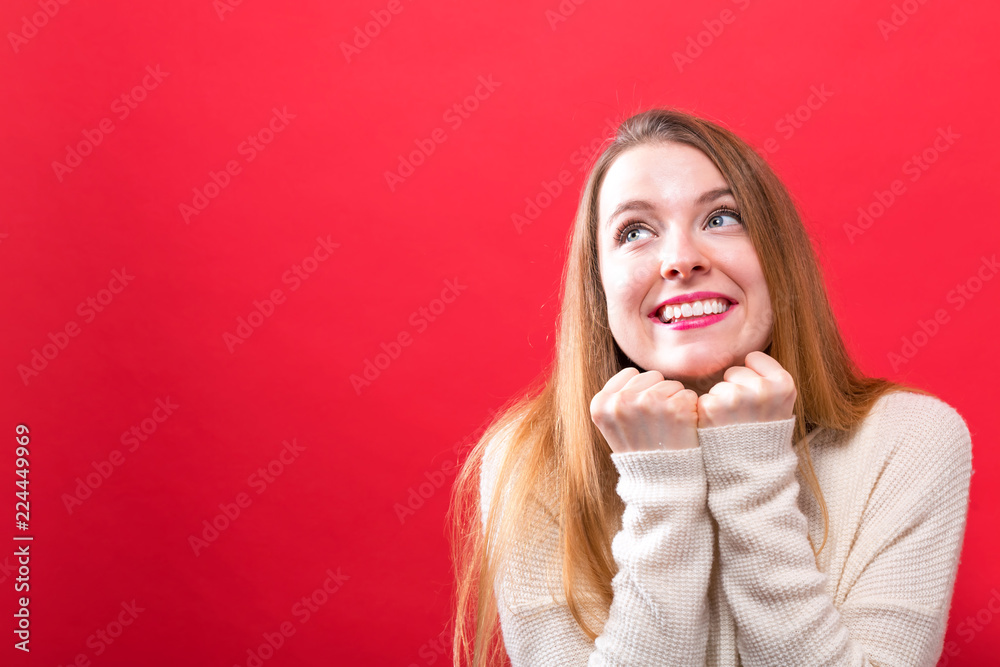 Happy hopeful wishful young woman on a solid background Happy hopeful wishful young woman on a solid background