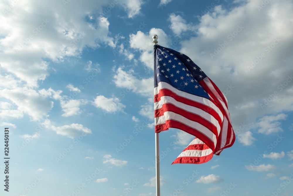 American Flag Waving Against Blue Sky