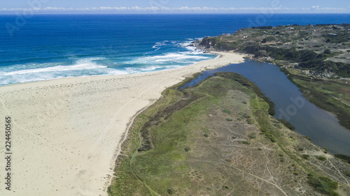 An aerial drone view over Tunquen Beach in Valparaiso region and close to Algarrobo, an awesome beach with a lot of wildlife because of it wetlands and turquoise waters, an idyllic travel destination photo