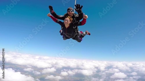 Tandem skydiving, regrouping in the air, until opening the parachute photo