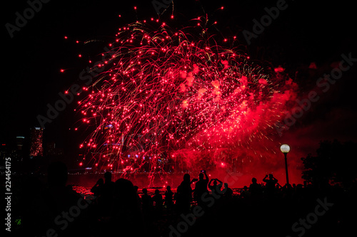 Beautiful red fireworks with people background at night