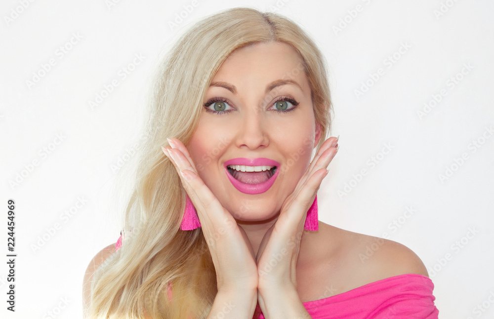 A beautiful young blonde with a surprised smile and holding her hands in front of her face, opening her mouth. A beautiful young blonde with a surprised smile and holding her hands in front of her face, opening her mouth.