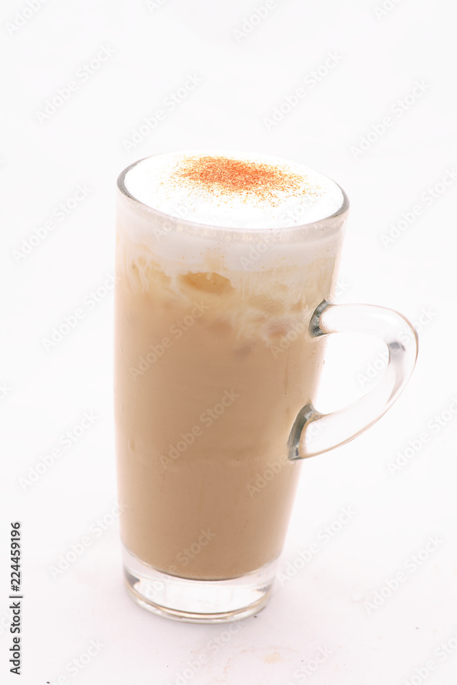 Cappuccino Cold Coffee In a glass on a white floor in the studio. Cappuccino Cold Coffee In a glass on a white floor in the studio.