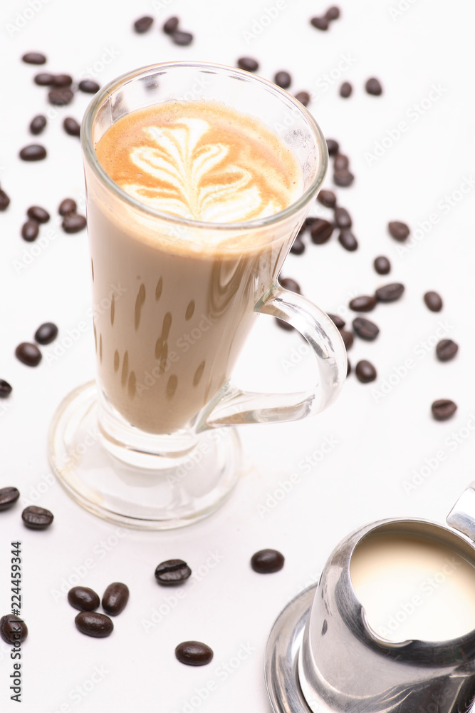 Hot Cappuccino coffee in clear glass on a white background in the studio. Hot Cappuccino coffee in clear glass on a white background in the studio.