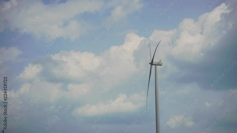 A wind turbine on blue sky background. A wind turbine on blue sky background.