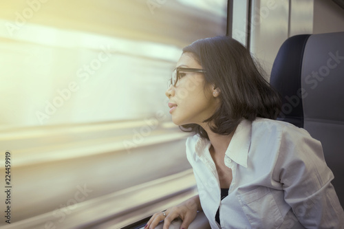 Free Download Pretty entrepreneur looking out a train window - GFXLoad