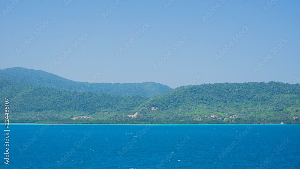 a karimun jawa big island with mountain view from ship with blue sea and sky