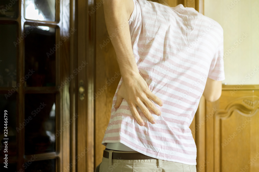 tired exhausted young man suffer from strong backache f tired exhausted young man suffer from strong backache f