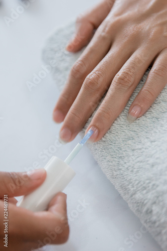 Beautician using a nail polish 