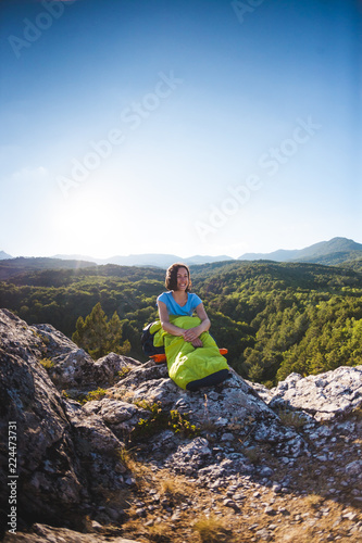 A woman is sitting in a sleeping bag.