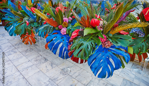 Bouguets of monstera for tables decoration on wedding or corporative event photo