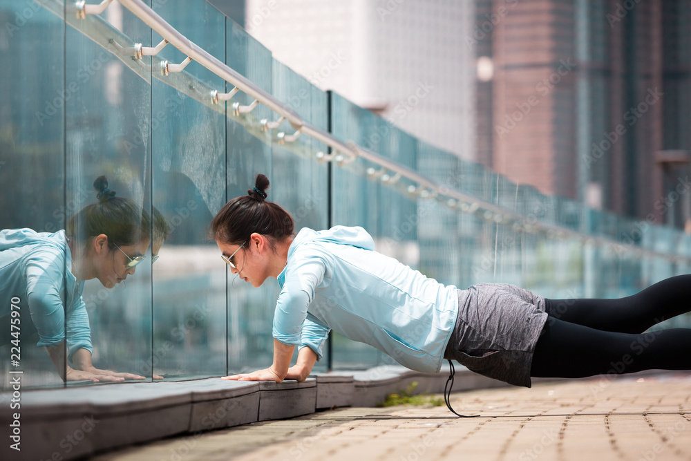 Fitness young woman workout early morning in the city 