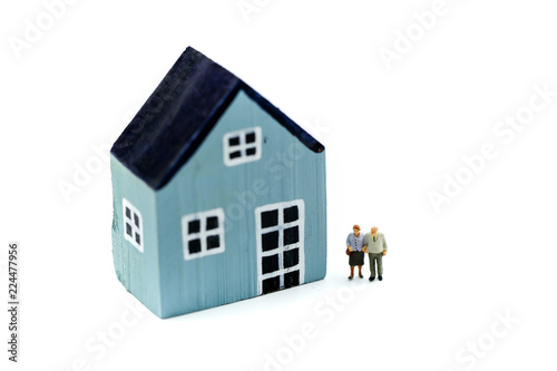 Miniature people: Couple of Oldmans standing with house, money saving growth. Retirement, emergency plan and Financial Concept. photo