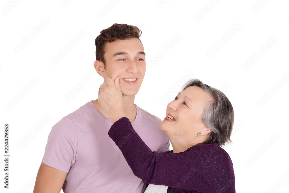Grandmother kissing her teen grandson on the cheek Grandmother kissing her teen grandson on the cheek