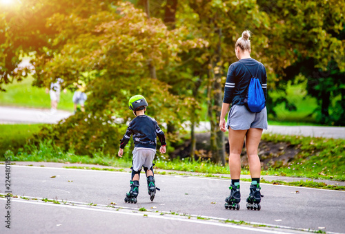 Mom and son roller skating in the Park 