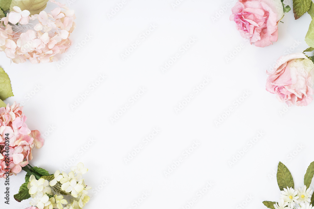 Frame made of pink and beige roses, green leaves, branches on white background. Flat lay, top view. Wedding's background Frame made of pink and beige roses, green leaves, branches on white background. Flat lay, top view. Wedding's background