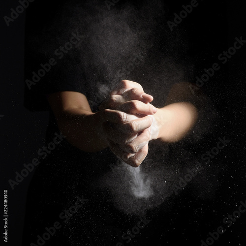 hand with flour dusk on blackboard © adisak
