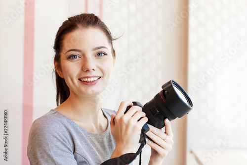 Portrait of Girl photographer smiling and holding her camera