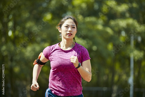 young asian woman training outdoors