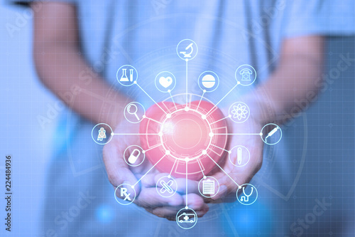 doctor holding red heart shape in hand with medical,Medicine,technology,science icon network connection modern virtual line and dots screen interface Structure communication. Big Data Visualization.